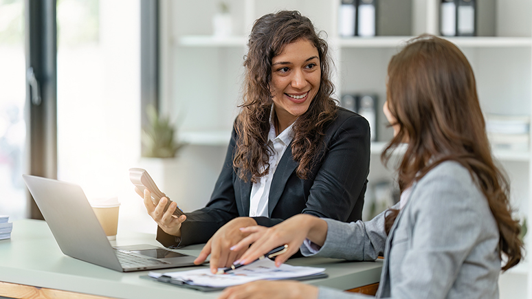 two people speaking in an office