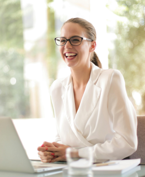 A woman smiling at her desk